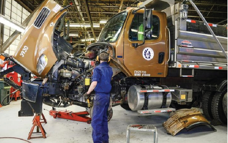 a white car with a green gas pump