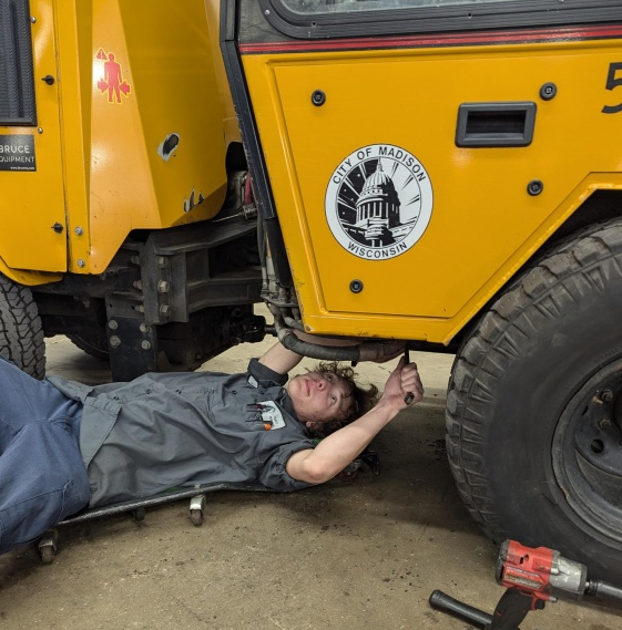 a man working on a motorcycle in a garage